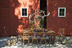 Autumnally set dinner table outside barn (USA, East Coast, New England)