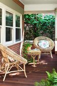 Veranda with brown deck and round wicker furniture