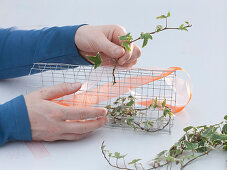 Table arrangement of silk poppy in wire mesh
