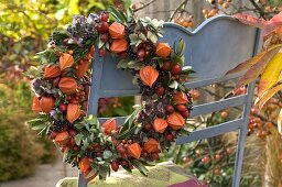 Wreath with lantern flowers, rosehips and olive branches