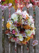 Autumnal flower wreath at the fence