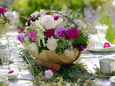 Table decoration of roses and elderberry
