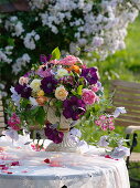 Romantic arrangement made of roses and clematis (clematis)