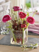 Dogwood branches as plug-in aid for ranunculus bouquet