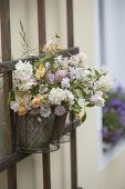 Put bouquet of roses in hanging pot on trellis