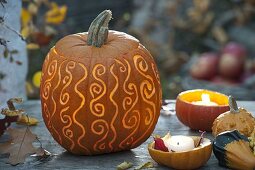Ornamental carved pumpkin (Cucurbita) with ornaments