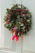 Autumnal wreath made of Ilex (holly) with red berries