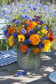 Tying blue-orange summer flower bouquet
