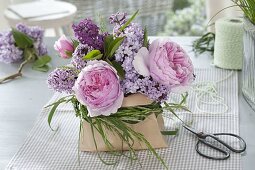 Small bouquet of rose and syringa with sleeve