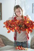 Physalis wreath with fairy lights as hanging table decoration