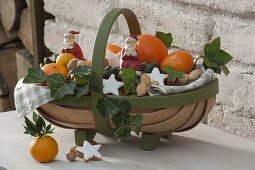 Nikolauskorb gefüllt mit Orangen und Clementinen (Citrus), Zimtsternen