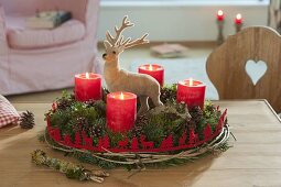 Red-green Advent wreath of mixed conifers and Buxus