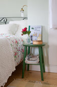 Green stool used as bedside table