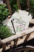 Book cover embroidered with floral motifs in vintage pull-along cart