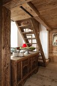 Rustic wooden staircase and antique trunk in chalet
