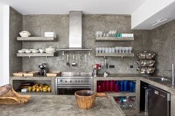 Open shelves and rustic wooden containers in kitchen with moulded concrete elements