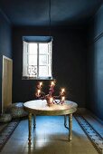 Chandelier on table in blue room with patterned floor