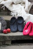 Hand-made felt slippers and fringed blanket on vintage stone steps