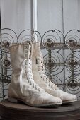 Pair of old boots in front of mattress springs