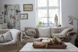 Antlers on tray in front of sofa with scatter cushions made from old flour sacks