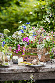 Lavish bouquet of wildflowers in wooden crate decorating table