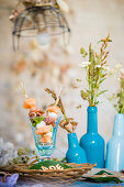 Melon skewers in glass on table set in summery style