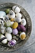 Easter eggs variously decorated in antique silver dish
