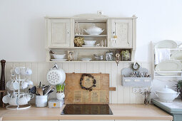 Old wall-mounted cabinet above worksurface in country-house kitchen