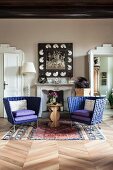 Two purple armchairs and side table in front of open fireplace