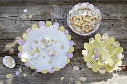Pastel paper baskets and Easter eggs decorated with paper flowers