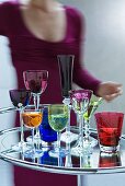 Colourful drinking glasses on Art-Deco bar trolley