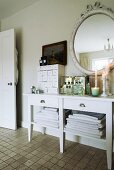 Vintage-style accessories on white console table in bathroom