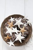 Folded white and brown paper stars on wreath