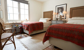 Twin beds with tall headboards in rustic bedroom