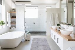 Free-standing bathtub in large bright bathroom