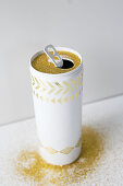 Vase hand-made from can using golden adhesive pattern