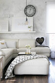 White leather sofa combination and vases hand-made from cans on ottoman