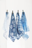 Old handkerchiefs hand-dyed using Shibori technique hung from line