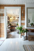 View from hallway with rustic board wall into country-house kitchen