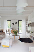 Wood-beamed ceiling and white floor in bright living room