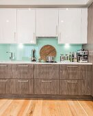 Elegant fitted kitchen with glass splashback and white wall units