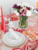 Colorfully laid table with bouquet and colored candles