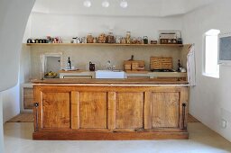 Wooden island counter in traditional kitchen in trullo