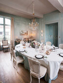 Festively set table in antique dining room with panelled walls