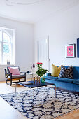 Blue sofa and delicate coffee table in living room of period apartment