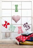 'I heart XMAS' made from fabric letters hung from lattice window