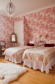 Twin beds in bedroom with red Toile de jouy wallpaper