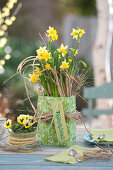 Narcissus 'Tete a Tete', decorated with grass, as a gift