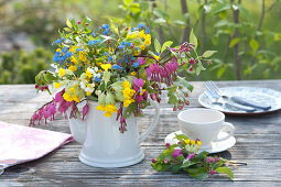 Colorful spring bouquet in coffee pot,