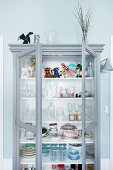 Collection of crockery and glasses in grey display case